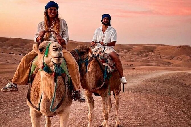 Couple on a sunset camel ride in the Agafay desert near Marrakech